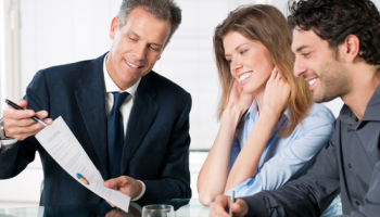 Attorney-showing-documents-to-a-smiling-couple.jpg