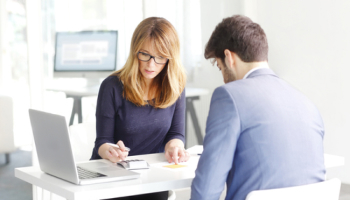 Two-people-discussing-documents-in-an-office.jpg